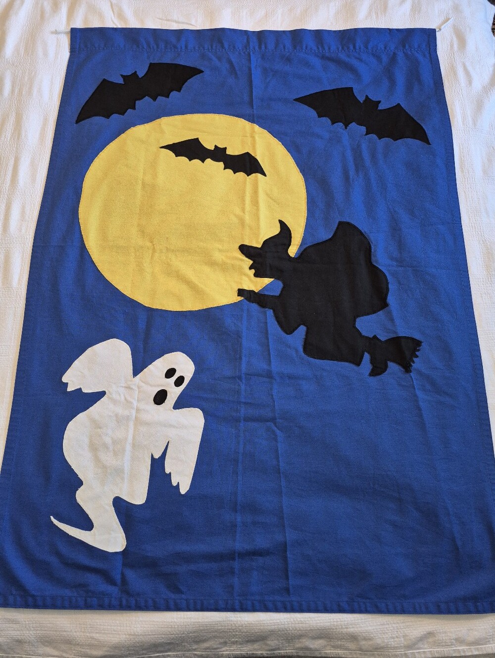 Halloween banner blue background, has a witch, yellow moon, bats, and a ghost